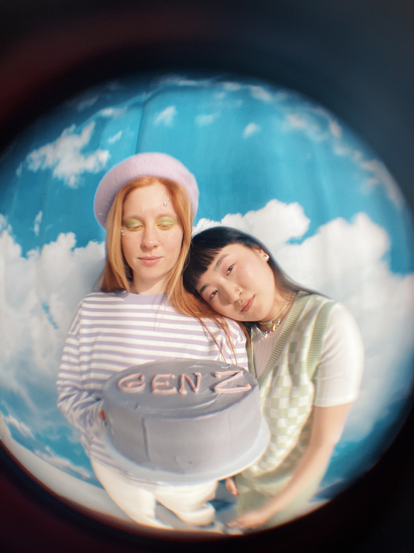 Fisheye Photo of a Teenagers Holding a Gen Z Cake